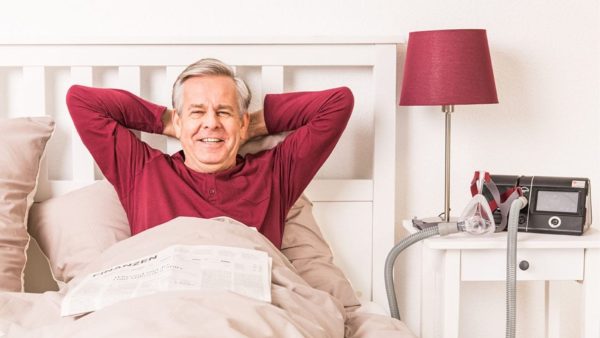 Man in bed with CPAP